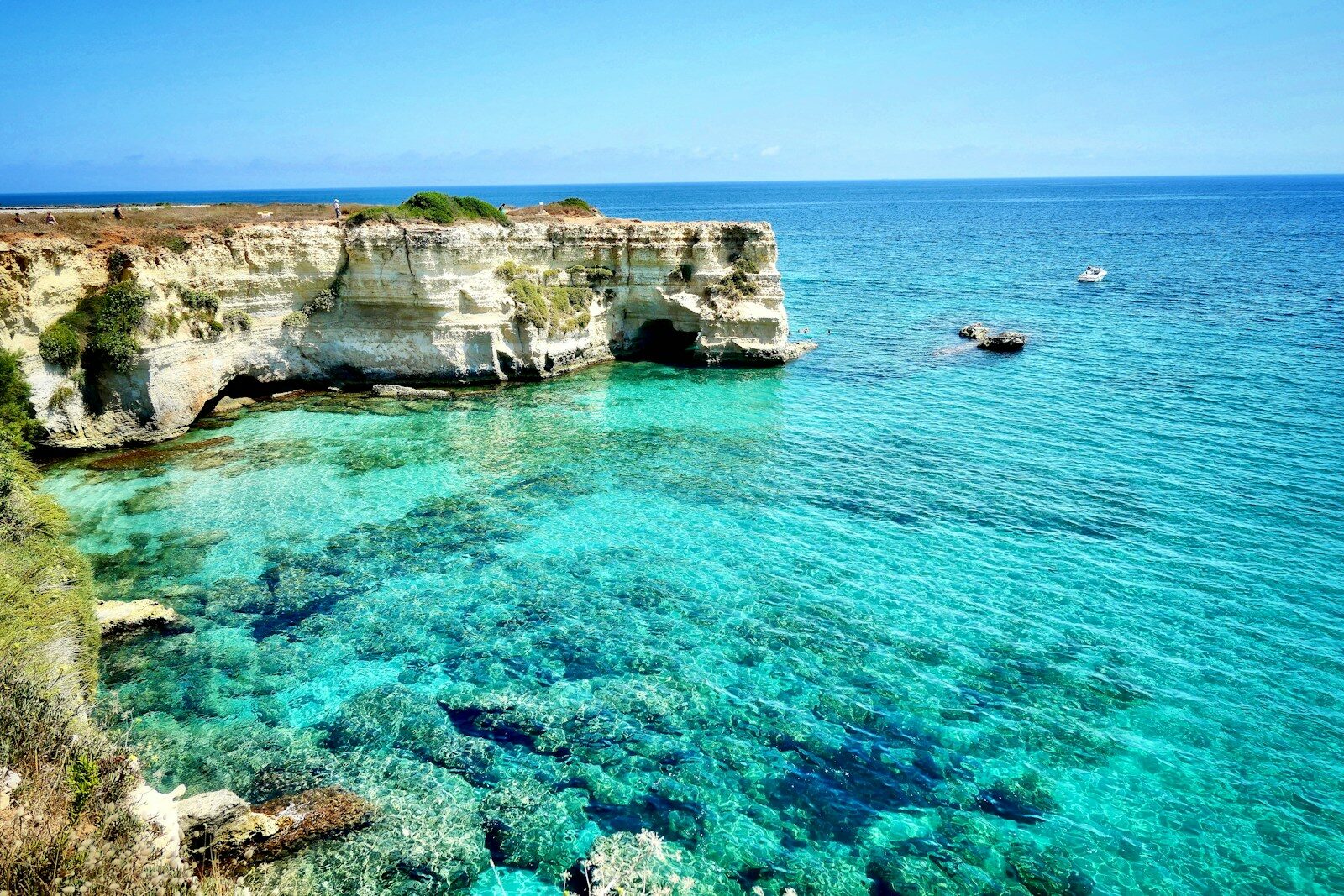 brown rock formation on blue sea during daytime
